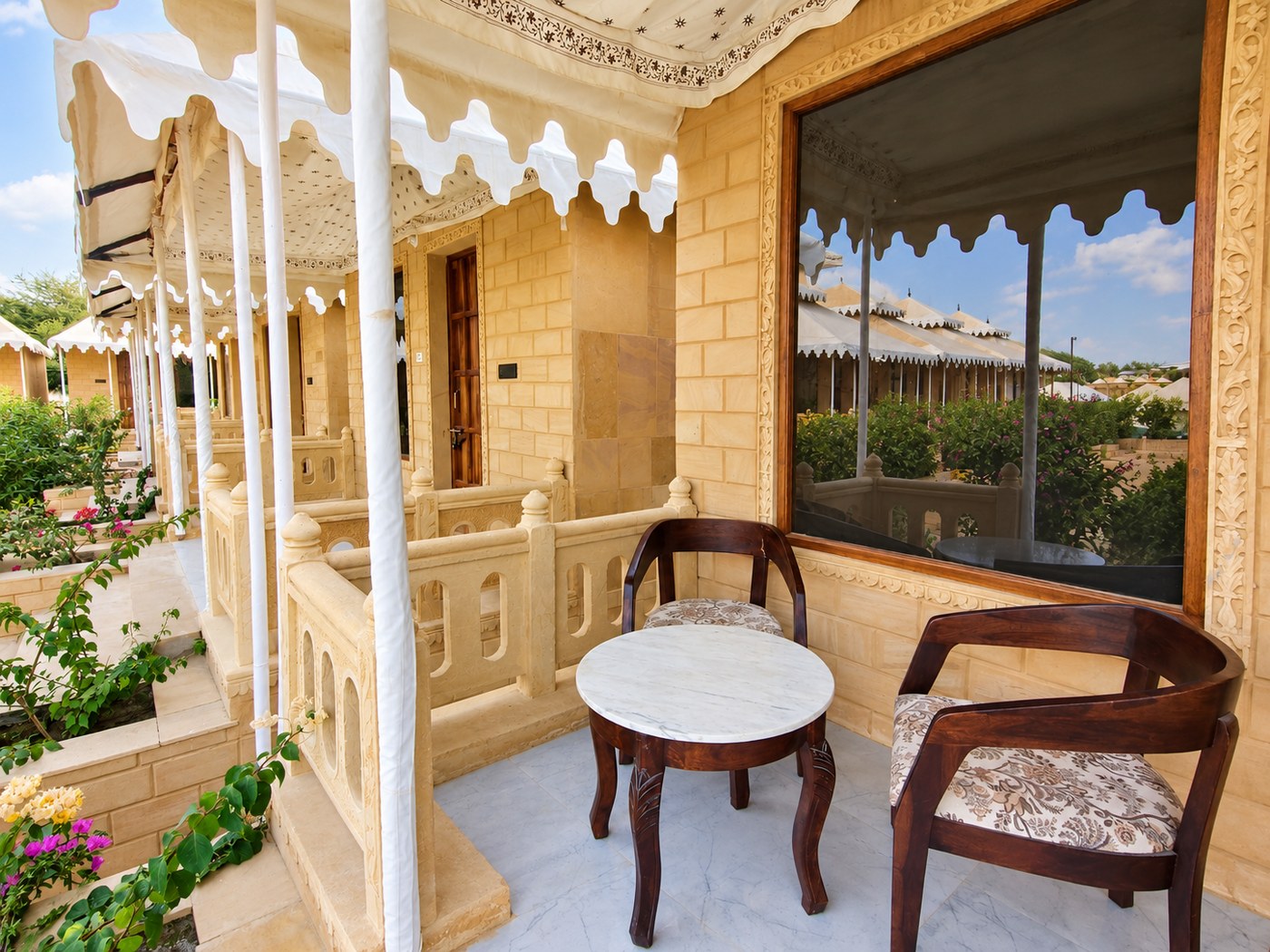 Sandstone porch with carved railings at The Desert Mafia Resort