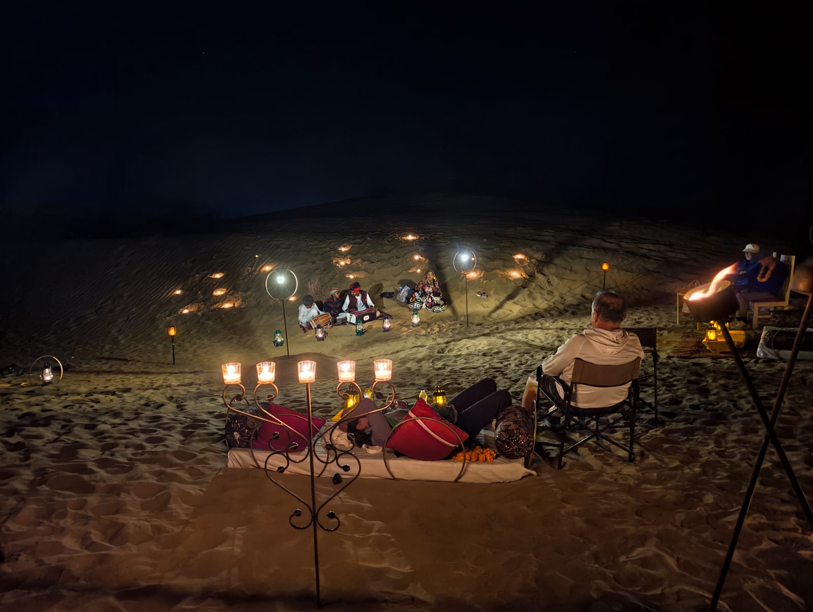Folk musicians playing on the dunes for a candle-lit dinner