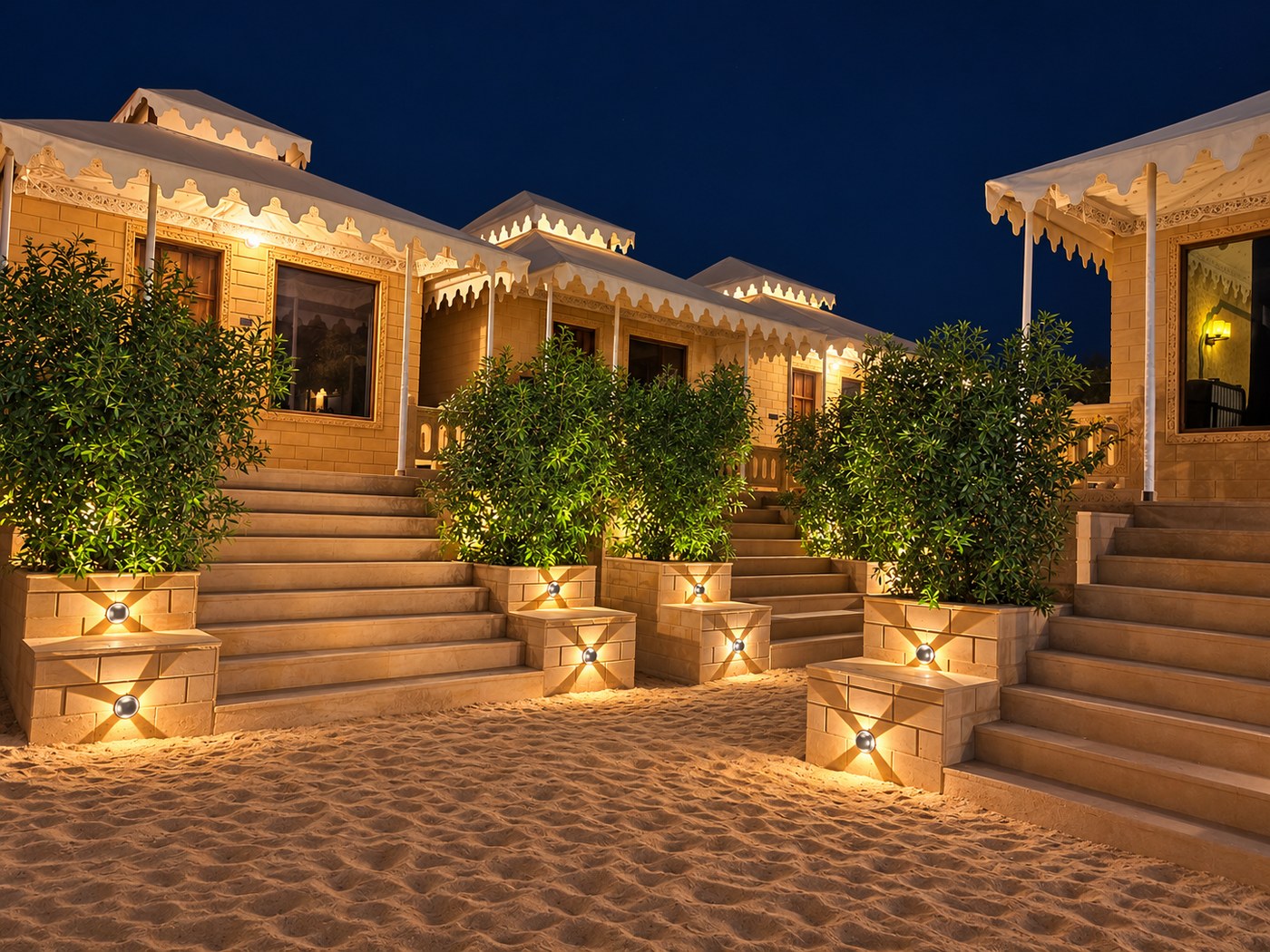 Lit steps leading up to the cottages at night