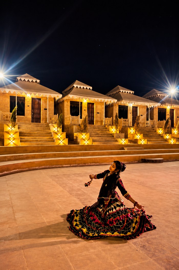 Folk dancer in a Rajasthani ghagra performing at night in the camp