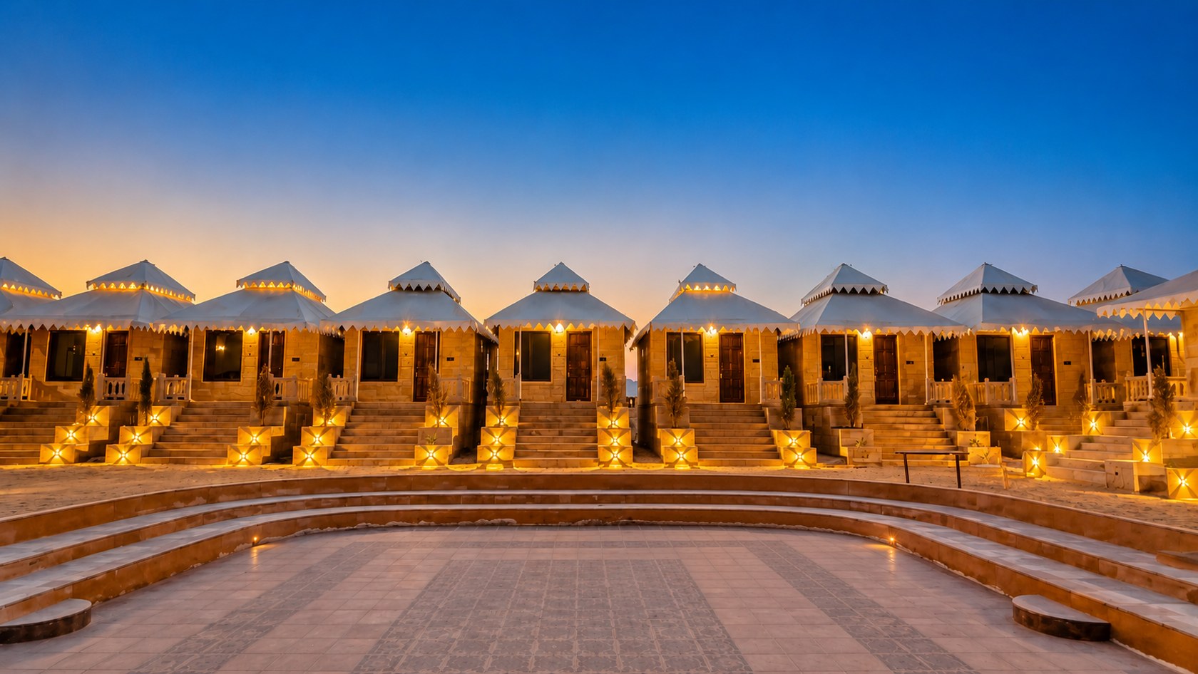Desert Mafia Resort cottages lit at dusk around the courtyard